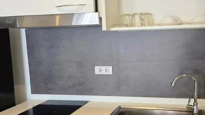 a kitchen counter with a sink and aswitch on the wall at Boutique Comfort 1BR T2-410 in Chalong