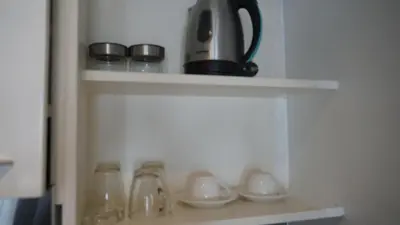 a shelf with a tea pot and cups on it at Boutique Comfort 1BR T2-410 in Chalong