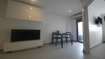 a living room with a table and a flat screen tv at Boutique Comfort 1BR T2-410 in Chalong