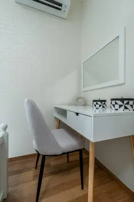 a white desk with a chair and a mirror at Two Flamingo Apartment 1 in Nai Yang Beach