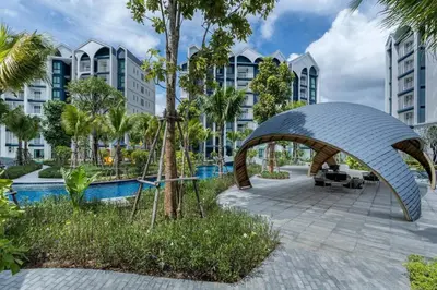 a resort with a swimming pool and a building at Two Flamingo Apartment 1 in Nai Yang Beach