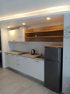 a kitchen with a sink and a refrigerator at Modern & Cozy Apartment 1BR - NV-413 in Chalong