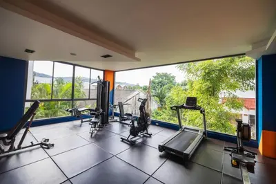 a gym with tread machines and a large window at Modern & Cozy Apartment 1BR - NV-413 in Chalong