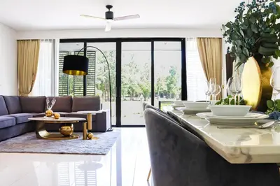 a living room with a table and a couch at Cassia 3BR with Terrace Sea view apt by NLA in Phuket Town