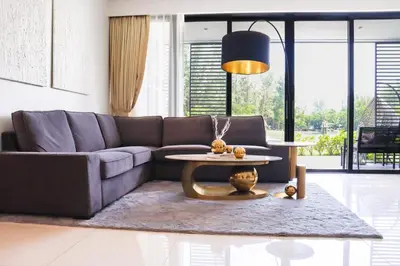 a living room with a couch and a table at Cassia 3BR with Terrace Sea view apt by NLA in Phuket Town