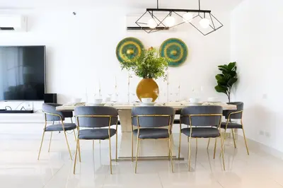 a dining room with a table and chairs at Cassia 3BR with Terrace Sea view apt by NLA in Phuket Town