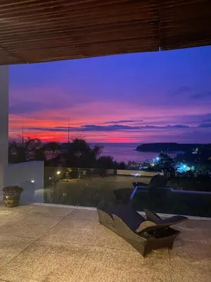 a view of a sunset from the balcony of a house at Panoramic Sea View Luxury Apartment - Leelawadee21 in Kata Beach