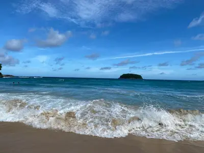 a beach with the ocean and a small island at Panoramic Sea View Luxury Apartment - Leelawadee21 in Kata Beach