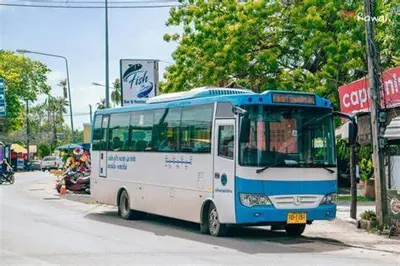 a blue and white bus parked on the side of a street at Panoramic Sea View Luxury Apartment - Leelawadee21 in Kata Beach