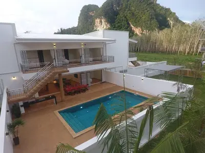 an aerial view of a house with a swimming pool at Amidst tropical plantations and striking mountain views in Ban Khlong Haeng