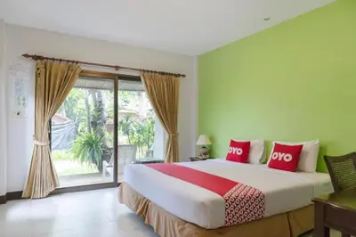 a bedroom with a large bed with red pillows at OYO 1046 Noppharat resort in Ao Nang Beach