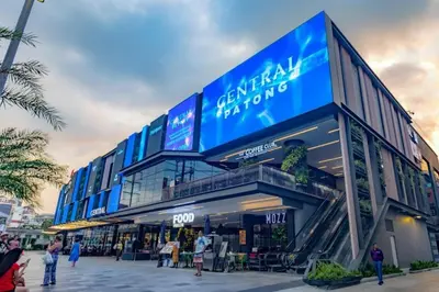 a shopping center with a large sign on the side of it at Patong Station House in Patong Beach