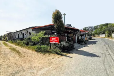 a building on the side of a road with a no parking sign at OYO 503 Phuket Numnoi in Surin Beach