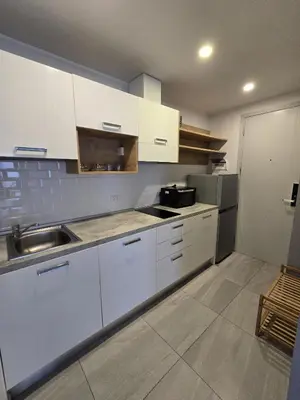 a kitchen with white cabinets and a sink at Cozy & Modern -1BR - T2 416 in Phuket Town