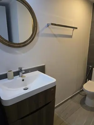 a bathroom with a white sink and a mirror at Cozy & Modern -1BR - T2 416 in Phuket Town