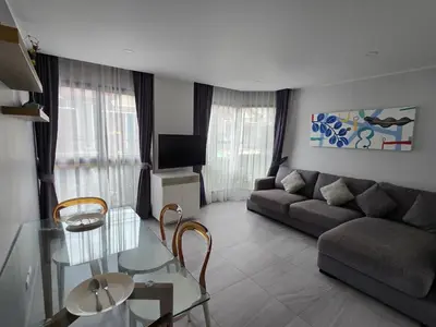 a living room with a couch and a glass table at Cozy & Modern -1BR - T2 416 in Phuket Town