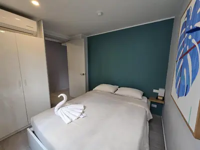 a room with a bed with a swan on it at Cozy & Modern -1BR - T2 416 in Phuket Town