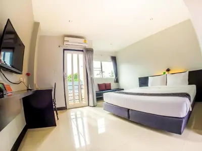 a large bedroom with a large bed and a television at My Place Phuket Airport Mansion in Ban Bo Han