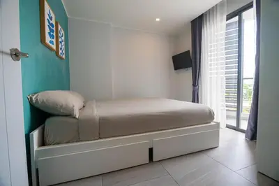 a small bed in a room with a window at 1BR Apartment near Villa Market - NV-423 in Phuket Town