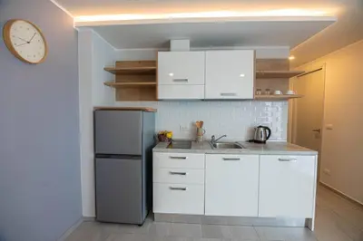 a kitchen with white cabinets and a refrigerator at 1BR Apartment near Villa Market - NV-423 in Phuket Town