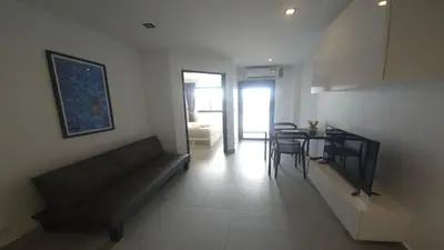 a living room with a couch and a table at Tranquil Tide 1 BR T1-605 in Chalong