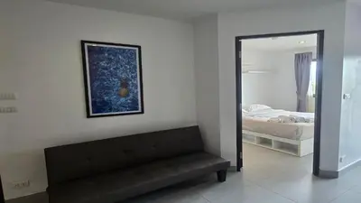 a living room with a couch and a mirror at Tranquil Tide 1 BR T1-605 in Chalong