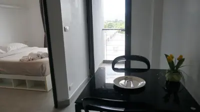 a bedroom with a view of a bed and a mirror at Tranquil Tide 1 BR T1-605 in Chalong