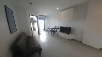 a living room with a couch and a table at Tranquil Tide 1 BR T1-605 in Chalong
