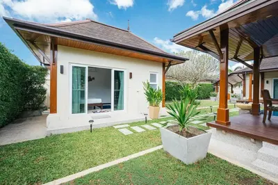 a house with a porch and a patio at Tranquil 3 Bedroom Garden Pool Villa in Laguna Phuket