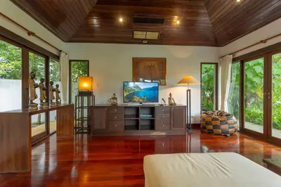 a living room with a tv and some windows at Surin 4-Bed Luxury Retreat with Private Pool V131 in Thalang