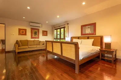 a bedroom with a bed and a couch at Surin 4-Bed Luxury Retreat with Private Pool V131 in Thalang