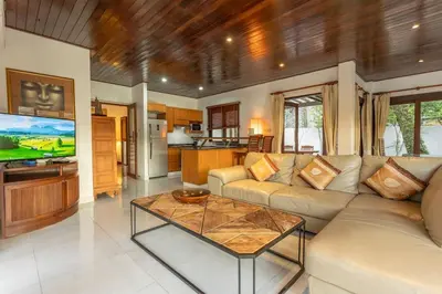 a living room with a couch and a table at Surin 4-Bed Luxury Retreat with Private Pool V131 in Thalang