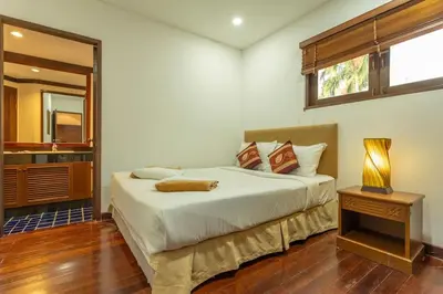 a bedroom with a large bed and a window at Surin 4-Bed Luxury Retreat with Private Pool V131 in Thalang
