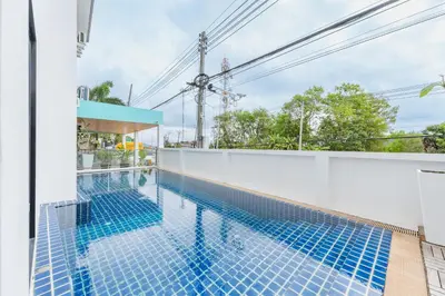 a swimming pool on the side of a building at De Blue Sea Rawai Hotel in Ban Saiyuan (1)