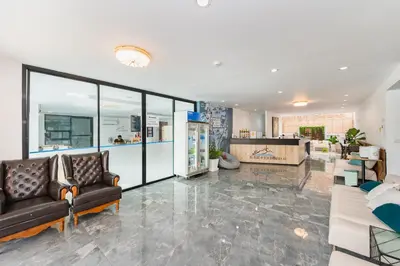 a living room with two couches and a lobby at De Blue Sea Rawai Hotel in Ban Saiyuan (1)