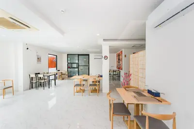 a restaurant with tables and chairs in a room at De Blue Sea Rawai Hotel in Ban Saiyuan (1)