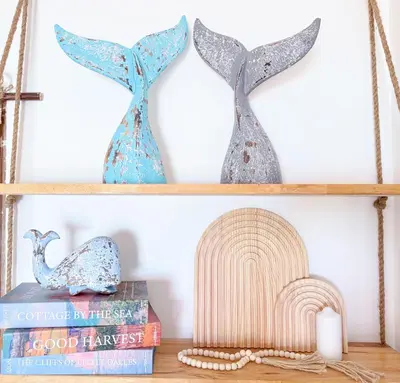two dolphin vases sitting on a shelf at Sea Dreamer Ao Yon Beach House in Ban Ao Makham
