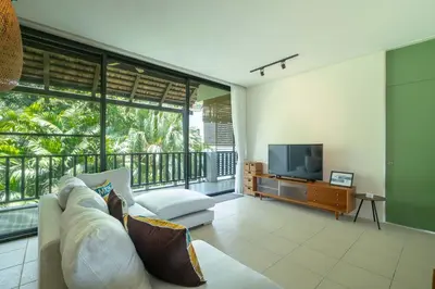 a living room with a couch and a television at Stylish Penthouse at Bangtao Beach in Surin Beach