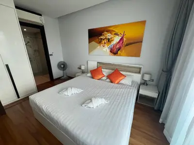 a bedroom with a white bed with orange pillows at Emerald Terrace Condo 9-1 Bed City & Mountain in Patong Beach