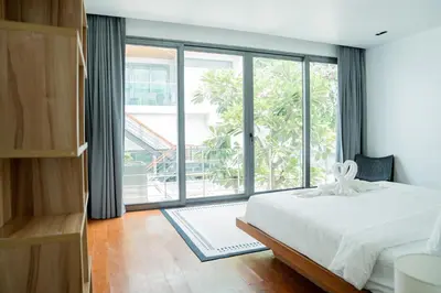 a bedroom with a bed and a large window at Eva8\u4e09\u5367\u6d77\u666f\u6cf3\u6c60\u522b\u5885\u4e34\u6d77\u522b\u5885 in Rawai Beach