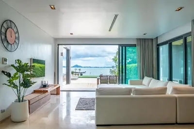a living room with a white couch and a large window at Eva8\u4e09\u5367\u6d77\u666f\u6cf3\u6c60\u522b\u5885\u4e34\u6d77\u522b\u5885 in Rawai Beach