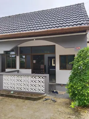 a house with a gate in front of it at Suthida Resort in Rawai Beach