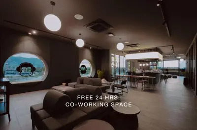 a living room with a couch and a dining room at Blu Monkey Hub and Hotel Laguna, Bangtao Phuket in Bang Tao Beach