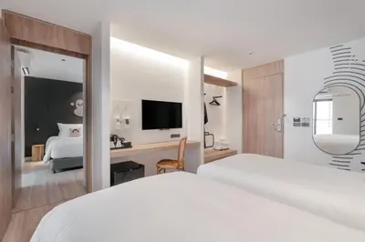 a hotel room with a bed and a tv at Blu Monkey Hub and Hotel Laguna, Bangtao Phuket in Bang Tao Beach