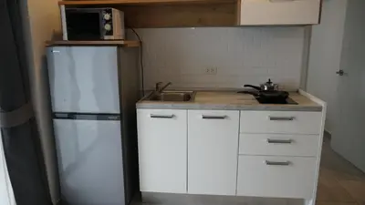 a kitchen with a white refrigerator and a sink at Well located Apt 1BR - T2-421 in Chalong