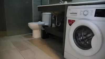 a washing machine in a bathroom with a toilet at Well located Apt 1BR - T2-421 in Chalong
