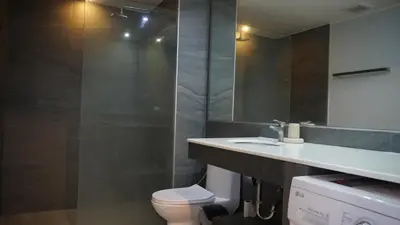 a bathroom with a sink and a toilet and a mirror at Well located Apt 1BR - T2-421 in Chalong
