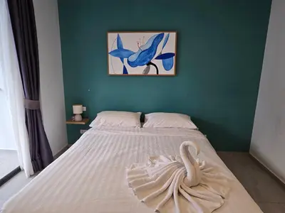 a bedroom with a bed with a swan on it at Well located Apt 1BR - T2-421 in Chalong