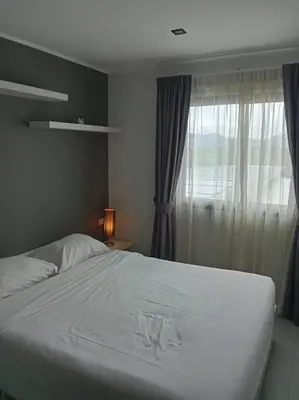 a bedroom with a white bed and a window at Fully Furnished Apartment - NV-622 in Chalong