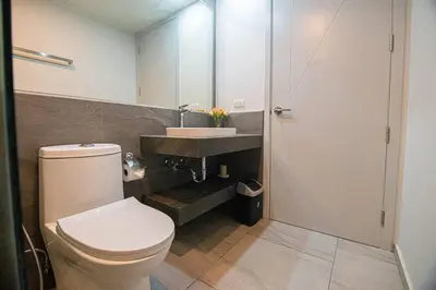 a bathroom with a toilet and a sink at Fully Furnished Apartment - NV-622 in Chalong